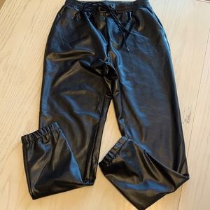 Women’s medium Black faux leather joggers with elastic drawstring waistband.